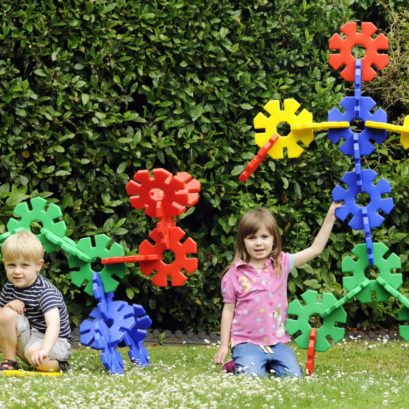 Groep kinderen bouwt samen een grote constructie met Octoplay tijdens een buitenspeelactiviteit op een vakantiepark. Groep kinderen bouwt samen een grote constructie met Octoplay tijdens een buitenspeelactiviteit op een vakantiepark.